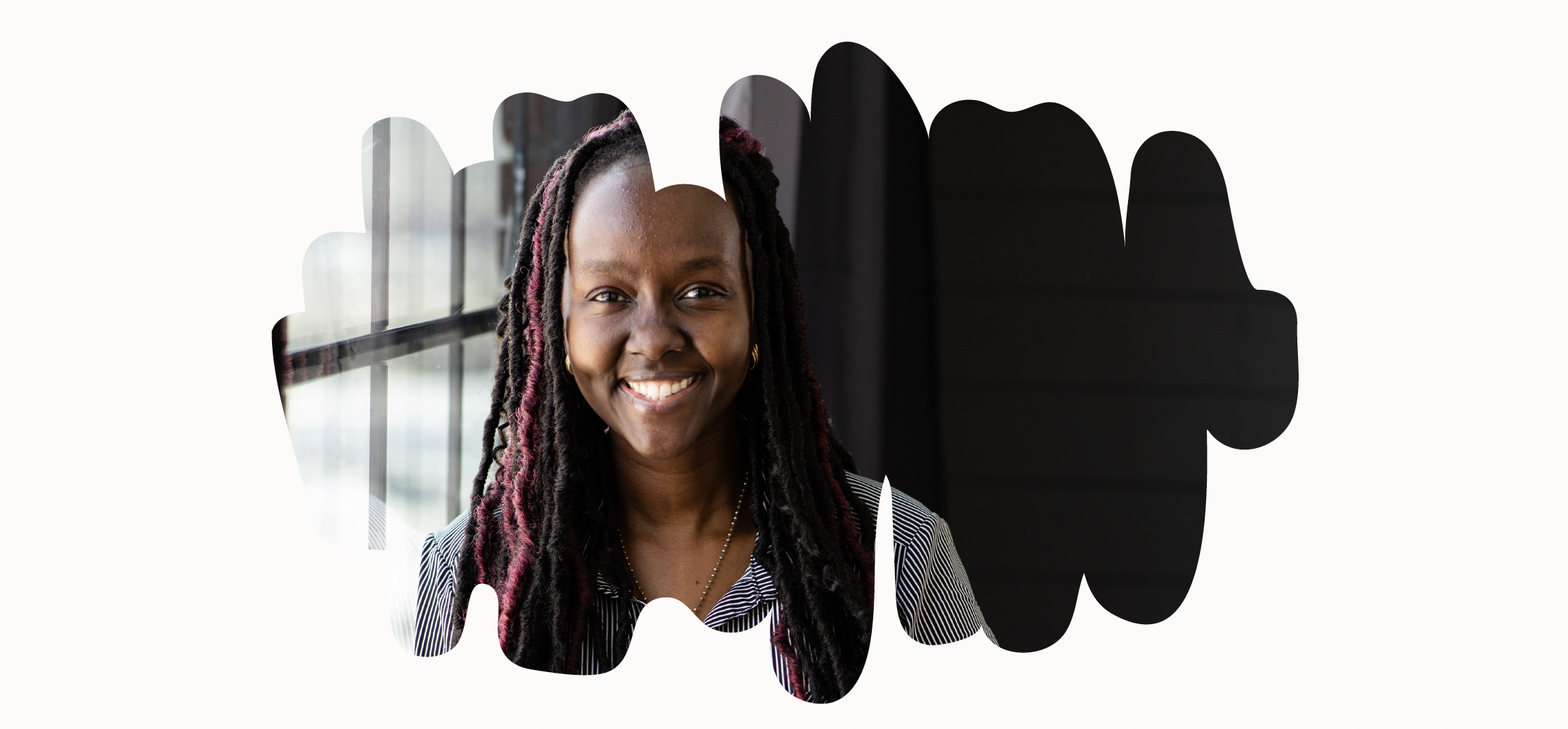 Headshot of Prof Kirabo standing by a window